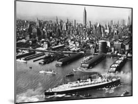 Tugboats Aid Ocean SS Queen Mary While Docking at 51st Street Pier with NYC Skyline in Background-null-Mounted Photographic Print