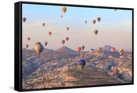 Turkey, Anatolia, Cappadocia, Goreme. Hot air balloons above Red Valley.-Emily Wilson-Framed Stretched Canvas