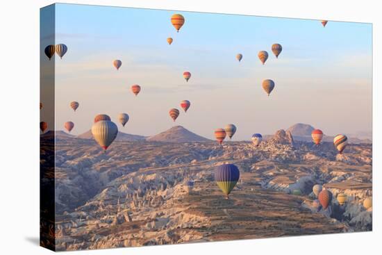 Turkey, Anatolia, Cappadocia, Goreme. Hot air balloons above Red Valley.-Emily Wilson-Stretched Canvas