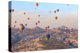 Turkey, Anatolia, Cappadocia, Goreme. Hot air balloons above Red Valley.-Emily Wilson-Stretched Canvas