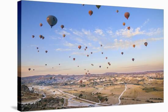 Turkey, Anatolia, Cappadocia, Goreme. Hot air balloons above Red Valley.-Emily Wilson-Stretched Canvas