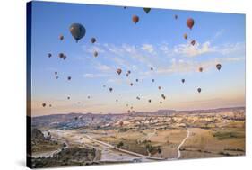 Turkey, Anatolia, Cappadocia, Goreme. Hot air balloons above Red Valley.-Emily Wilson-Stretched Canvas