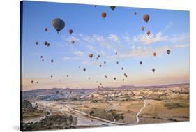 Turkey, Anatolia, Cappadocia, Goreme. Hot air balloons above Red Valley.-Emily Wilson-Stretched Canvas