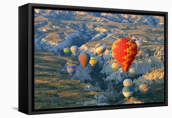 Turkey, Anatolia, Cappadocia, Goreme. Hot air balloons above Red Valley.-Emily Wilson-Framed Stretched Canvas