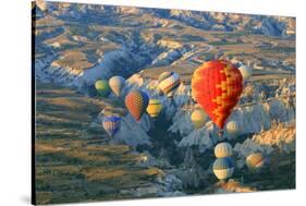 Turkey, Anatolia, Cappadocia, Goreme. Hot air balloons above Red Valley.-Emily Wilson-Stretched Canvas