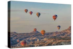 Turkey, Anatolia, Cappadocia, Goreme. Hot air balloons flying above the valley.-Emily Wilson-Stretched Canvas