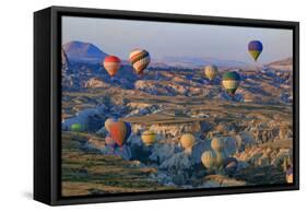 Turkey, Anatolia, Cappadocia, Goreme. Hot air balloons flying above the valley.-Emily Wilson-Framed Stretched Canvas