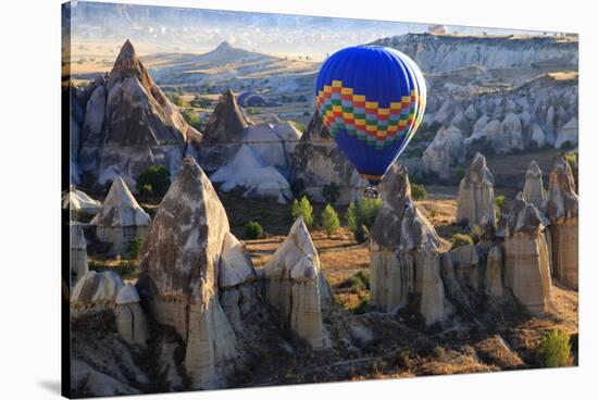 Turkey, Anatolia, Cappadocia, Goreme. Hot air balloons flying above the valley.-Emily Wilson-Stretched Canvas