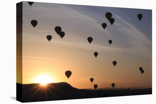 Turkey, Anatolia, Cappadocia, Goreme. Hot air balloons flying above the valley.-Emily Wilson-Stretched Canvas