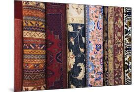 Turkey, Izmir, Selcuk, rolled and stacked rugs. Varieties of traditional patterns.-Emily Wilson-Mounted Premium Photographic Print