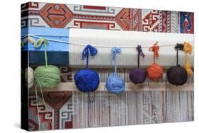 Turkey, Izmir, Selcuk, weaving loom with balls of wool or yarn.-Emily Wilson-Stretched Canvas