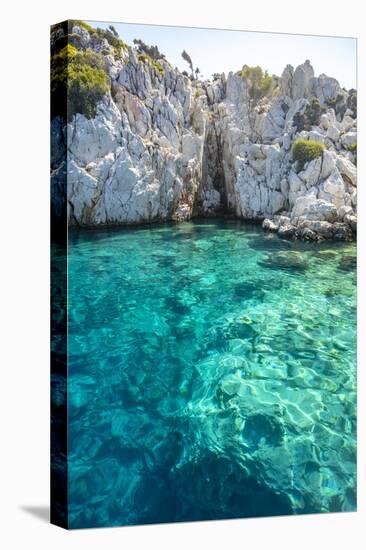 Turquoise colored crystal clear water at a rocky island, Aegean Sea, Turkey-Ali Kabas-Stretched Canvas