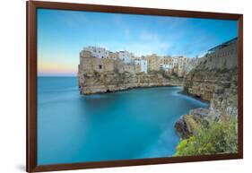 Turquoise sea at sunset framed by the old town perched on the rocks, Polignano a Mare, Province of -Roberto Moiola-Framed Photographic Print