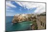 Turquoise sea framed by the old town perched on the rocks, Polignano a Mare, Province of Bari, Apul-Roberto Moiola-Mounted Photographic Print