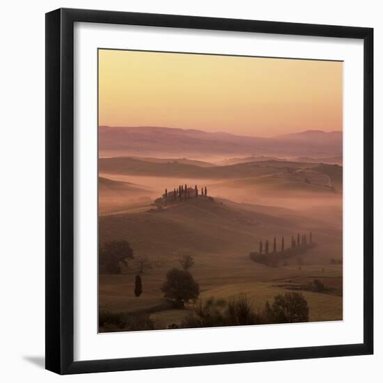 Tuscan farmhouse with cypress trees in misty landscape at sunrise, San Quirico d'Orcia-Stuart Black-Framed Photographic Print