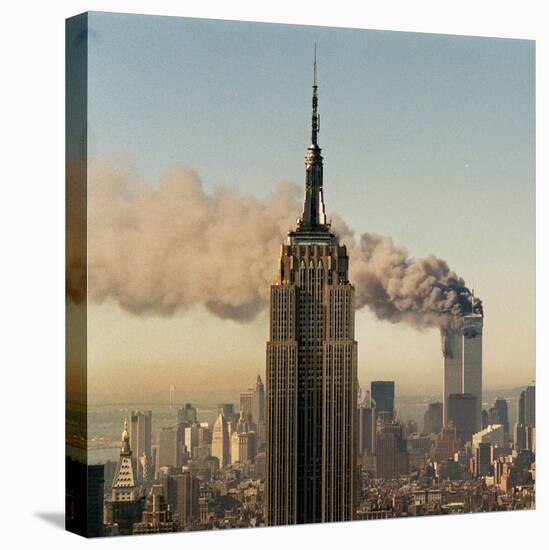 Twin Towers of the World Trade Center Burn Behind the Empire State Buildiing, September 11, 2001-null-Stretched Canvas