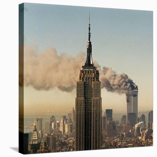 Twin Towers of the World Trade Center Burn Behind the Empire State Buildiing, September 11, 2001-null-Stretched Canvas