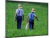 Two Amish Boys Walk with Their Golf Clubs Through a Field of Soy Beans-null-Mounted Photographic Print