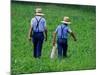 Two Amish Boys Walk with Their Golf Clubs Through a Field of Soy Beans-null-Mounted Photographic Print