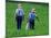 Two Amish Boys Walk with Their Golf Clubs Through a Field of Soy Beans-null-Mounted Photographic Print