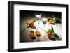 Two Antique Liqueur Glasses with Orange Liqueur and Small Oranges on White Wooden Table-Jana Ihle-Framed Photographic Print