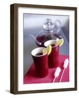 Two Beakers of Fruit Tea with Lemon Wedges, Sugar Sticks-Anita Oberhauser-Framed Photographic Print