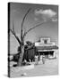 Two Boys Playing Nr. a Dead Tree as Judge Roy Langrty and a Man Walk Past a General Store-Alfred Eisenstaedt-Stretched Canvas