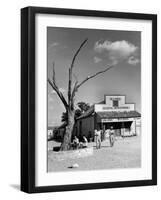 Two Boys Playing Nr. a Dead Tree as Judge Roy Langrty and a Man Walk Past a General Store-Alfred Eisenstaedt-Framed Photographic Print