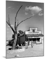 Two Boys Playing Nr. a Dead Tree as Judge Roy Langrty and a Man Walk Past a General Store-Alfred Eisenstaedt-Mounted Photographic Print