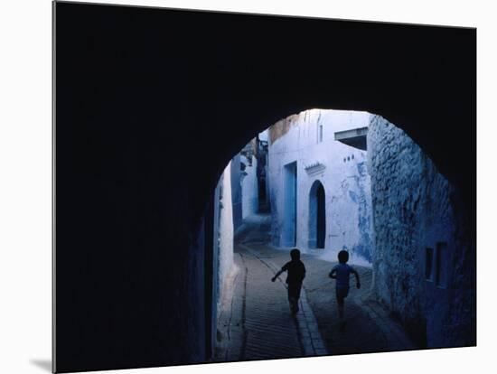 Two Boys Running Through Kasbah, Chefchaouen, Morocco-Jeffrey Becom-Mounted Photographic Print