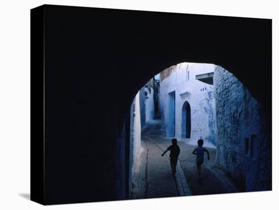 Two Boys Running Through Kasbah, Chefchaouen, Morocco-Jeffrey Becom-Stretched Canvas