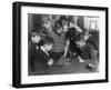 Two Boys Sit for a Game of Chess. Eight Spectators Look On-null-Framed Photographic Print