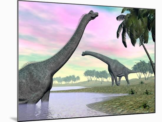 Two Brachiosaurus Dinosaurs in Landscape with Water and Palm Trees-null-Mounted Art Print