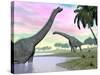 Two Brachiosaurus Dinosaurs in Landscape with Water and Palm Trees-null-Stretched Canvas