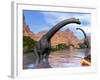 Two Brachiosaurus Dinosaurs in Water Next to Red Rock Mountains-null-Framed Art Print
