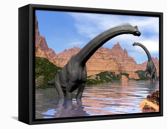 Two Brachiosaurus Dinosaurs in Water Next to Red Rock Mountains-null-Framed Stretched Canvas