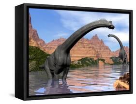 Two Brachiosaurus Dinosaurs in Water Next to Red Rock Mountains-null-Framed Stretched Canvas