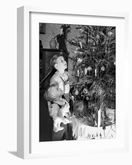 Two Brothers Look at a Christmas Tree in their Living Room in Germany, Ca. 1949-null-Framed Photographic Print