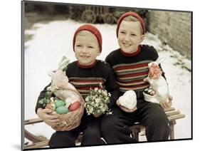 Two Brothers Sit with Easter Decorations Outside in Germany, Ca. 1948-null-Mounted Photographic Print