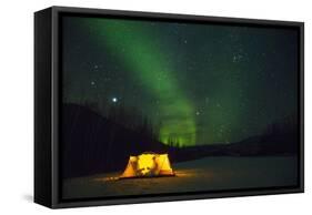 Two Campers Drinking a Bottle of Wine in a Tent under the Northern Lights-Jami Tarris-Framed Stretched Canvas