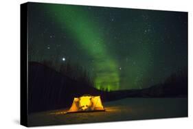 Two Campers Drinking a Bottle of Wine in a Tent under the Northern Lights-Jami Tarris-Stretched Canvas