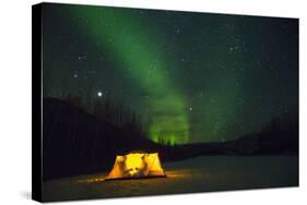 Two Campers Drinking a Bottle of Wine in a Tent under the Northern Lights-Jami Tarris-Stretched Canvas