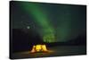 Two Campers Drinking a Bottle of Wine in a Tent under the Northern Lights-Jami Tarris-Stretched Canvas