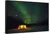 Two Campers Drinking a Bottle of Wine in a Tent under the Northern Lights-Jami Tarris-Framed Stretched Canvas