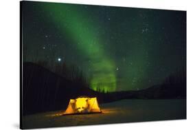 Two Campers Drinking a Bottle of Wine in a Tent under the Northern Lights-Jami Tarris-Stretched Canvas