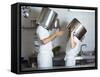 Two Chefs Having Discussion with Large Pans on their Heads-Robert Kneschke-Framed Stretched Canvas