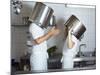 Two Chefs Having Discussion with Large Pans on their Heads-Robert Kneschke-Mounted Photographic Print