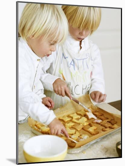 Two Children Brushing Biscuits with Glace Icing-Renate Forster-Mounted Photographic Print