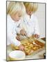 Two Children Brushing Biscuits with Glace Icing-Renate Forster-Mounted Photographic Print