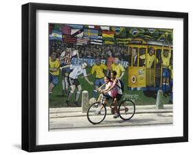 Two Children Ride Their Bicycle Pass a Mural-null-Framed Photographic Print